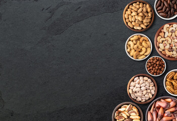 Assorted nuts over stone background with copy space