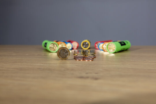 New collection of Bulgarian euro cents photographed on a wooden table. Colorful vertical columns with coins in denominations: 5, 10, 20, 50 cents and 1 euro. Selective focus and close-up.