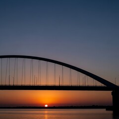 Obraz premium Sunset over a large bridge.