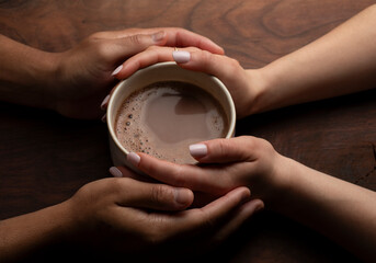 Hands Sharing a Warm Mug of Coffee in Moment of Connection and Romance