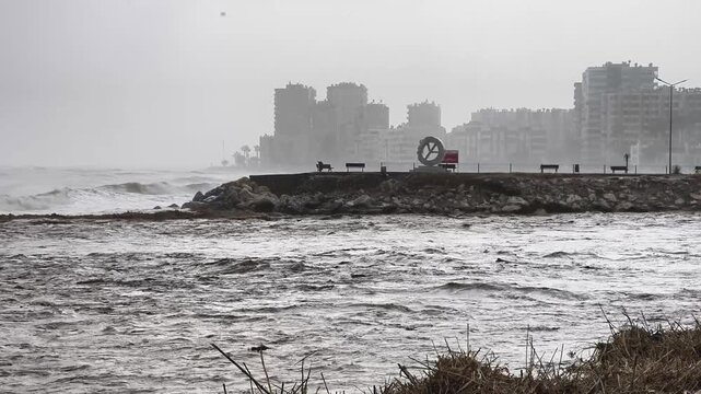 Sea waves merging with floodwaters on the Mersin Mezitli coast, Mersin, Turkey
