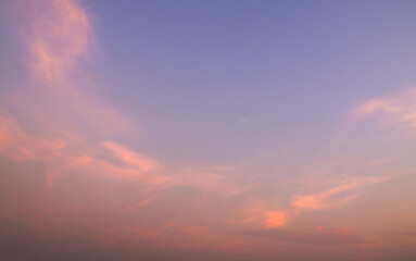 Fototapeta premium Soft ethereal sunset sky background with vibrant pastel pink and lavender clouds during twilight hours, symbolizing tranquility.