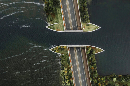 Aerial view of the Aquaduct Veluwemeer cutting through the water with its sleek design, a striking contrast against the natural waves, Harderwijk, Gelderland, Netherlands.