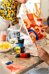 Friends enjoying art and wine painting workshop