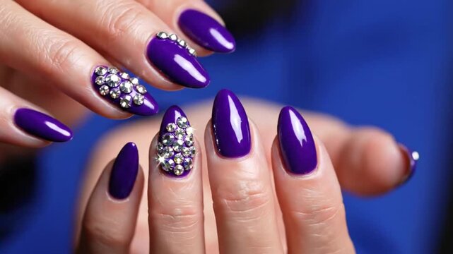 Elegant Purple Nail Design with Rhinestones on Hands against Blue Background, Beauty Concept