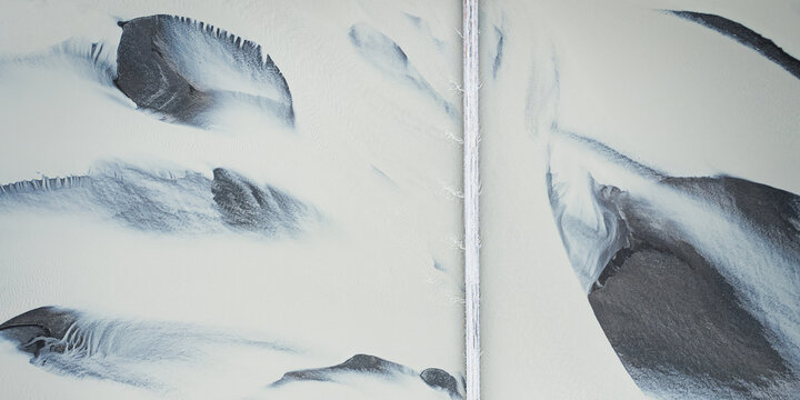 Aerial view of glacial rivers create stark patterns, a canvas of white sand cut by veins of dark water, Stafafell, Sveitarfelagid Hornafjordur, Iceland.