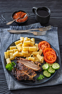 roasted pork ribs with pasta and fresh vegetables