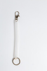 Close-up of transparent spiral key wrist strap with carabiner and ring