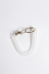 Close-up of transparent spiral keychain with metal carabiner