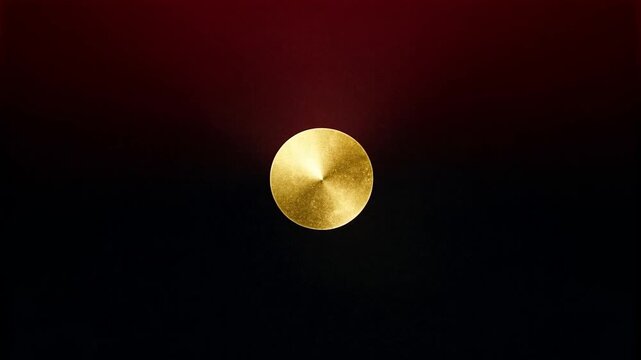 Zooming camera revealing centered gold brushed disc growing on red-black studio, with halo and dent