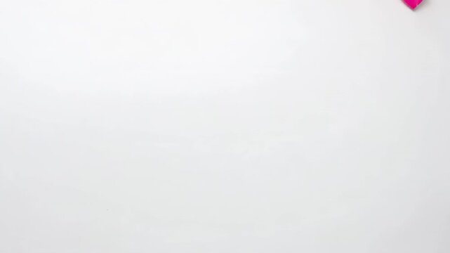 Panning camera revealing paper heart cluster moving upward on white backdrop, with confetti