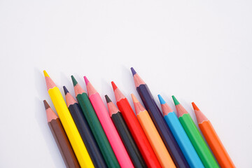 Fototapeta premium a collection of colorful pencils laid out on a white background