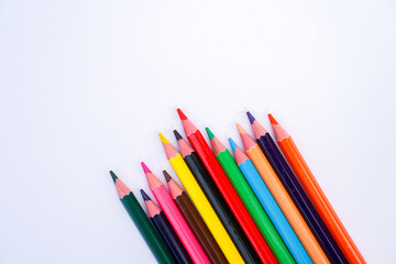 Fototapeta premium A collection of colored pencils arranged diagonally on a white background