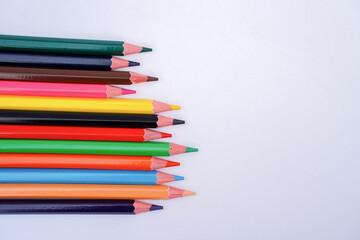 A colorful assortment of sharpened pencils arranged diagonally on a white background