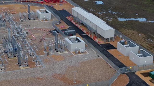 Aerial view of Biggleswade Substation, a landscape of industrial geometry, showcasing metallic frameworks against the stark backdrop, Biggleswade, Biggleswade, United Kingdom.