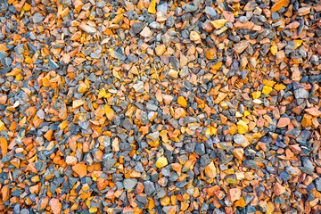 close up view of crushed brick and aggregate material with orange grey and blue hues