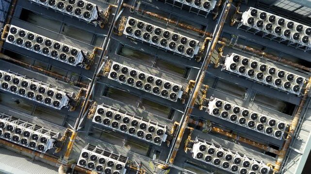 Aerial view of Rye House Power Station, with rows of cooling units and pipework creating a complex industrial landscape, Rye House, Hoddesdon, United Kingdom.