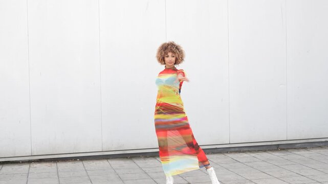 Vibrant Fashion Pose Wearing a Colorful Dress in a Lively Urban Setting and Background