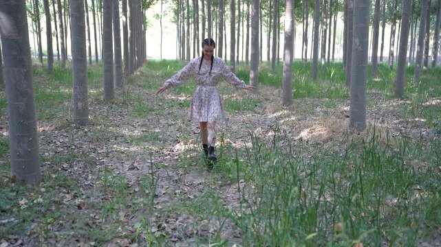 A Fashionable Woman Enjoying a Leisurely Stroll Through a Lush and Vibrant Forest