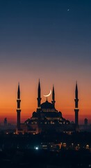 Mosque silhouette at sunset with minarets.