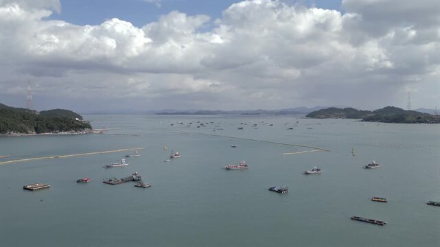 Aerial dolly shot showing sea farm and aquaculture industry near Jindo Island