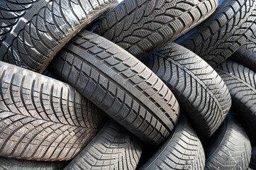 Old used car tires on a pile, industry dump, recycling rubber tire, vehicle service, junkyard with automobile material