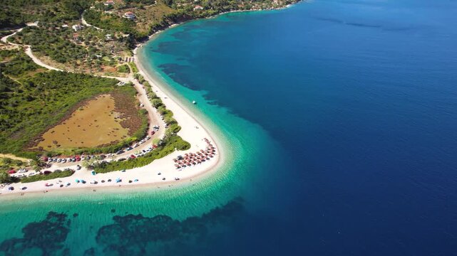 Aerial Cinematic Flight over Agios Dimitrios Beach Alonissos &mdash; 50 Shades of Blue Sea Water, White Pebble Sandspit and National Marine Park Mountains Panorama, Greece