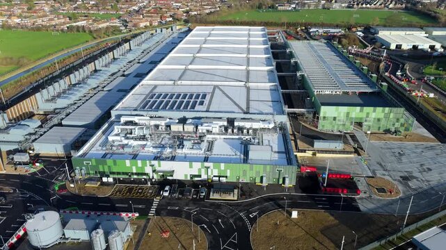 Aerial view of a large new build Google data centre with green accents and solar panels, Waltham Cross, Waltham Cross, United Kingdom.
