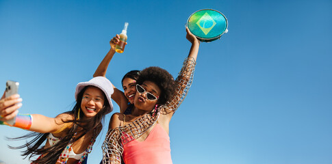 Friends celebrate at beach party with Brazil drum