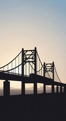Obraz premium Silhouette of a suspension bridge at sunset.
