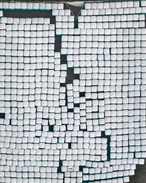 Aerial view of a geometric pattern of white cubes against a dark backdrop creates an abstract, minimalist scene, Mullenbach, Rhineland-Palatinate, Germany.
