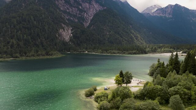 Aerial view of the tranquil Lago del Predil, its turquoise waters contrasting with the verdant mountains and lush forests, Tarvisio, Friuli-Venezia Giulia, Italy.