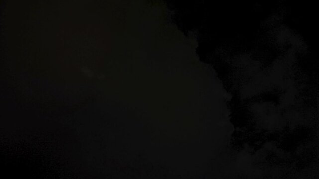 The moon is visible despite the dense cloud