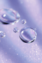 Water droplets on a lavender surface sparkle and shine softly.