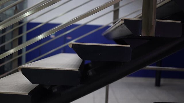 Modern metal staircase with clean geometric lines and industrial steps creating a minimal architectural scene with strong linear perspective structure and contemporary interior design atmosphere