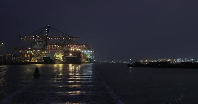 Loading containers on a cargo ships at night