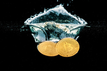 Bitcoin gold coins falling into the water. Splash of gold  crypto coins