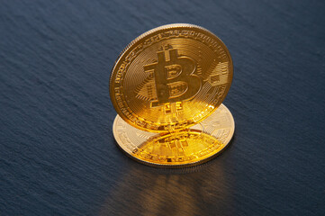 Bitcoin gold coins close up on a black background