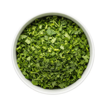Freshly chopped green coriander leaves in a white bowl isolated on transparent background