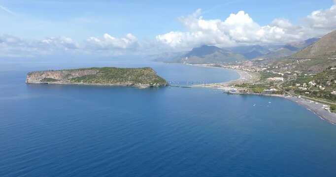 Aerial view of Isola di Dino, Italy. It is a tidal Italian island in the Tyrrhenian Sea, off the coast of Calabria. The island is situated off Cape Arena, near Praia a Mare. It is a sunny morning.