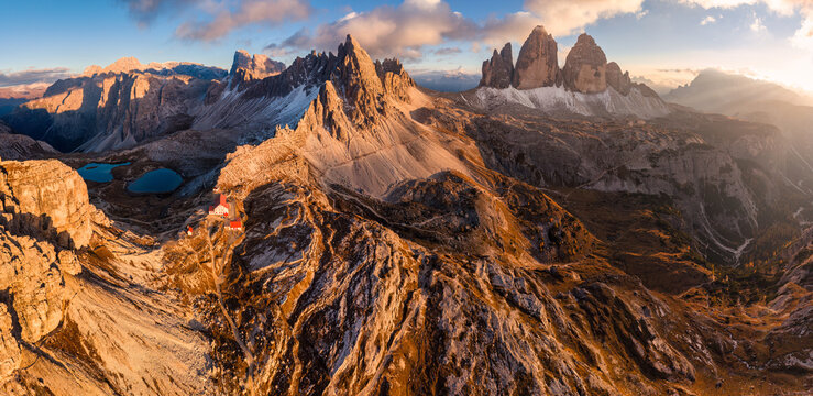 Scenic view of Tre Cime di Lavaredo peaks with Laghi dei Piani and Rifugio locatelli mountain hut in the sunset at Dolomites, italy