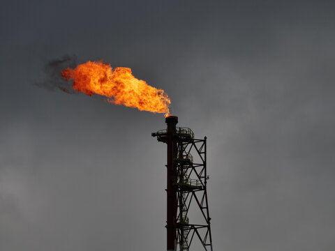   refinery fire gas torch on sky background