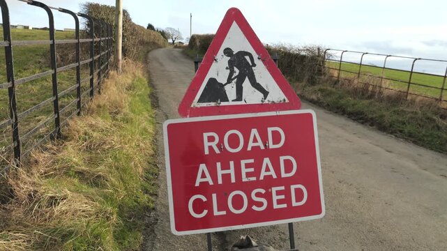 Road ahead closed sign on rural country lane in the UK
