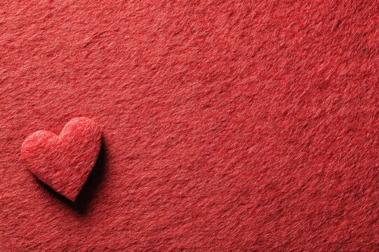 Red Paper Heart on Textured Background Symbolizing Love and Simplicity