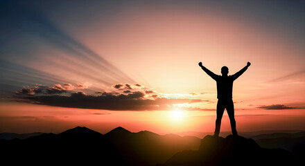 Fototapeta premium Man standing triumphantly on mountain peak at vibrant sunset