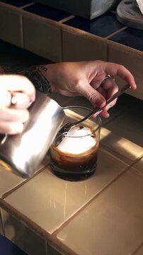 Professional Barista Crafting Specialty Coffee - Iced Espresso with Milk Foam