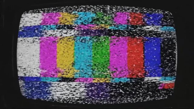 Screen shows static noise with no clear image or sound during late night broadcast interruption in urban setting