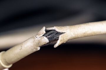 Old damaged electrical cable in macro