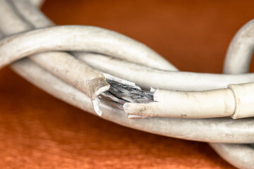 Worn out electrical cable. Damaged charging cable in macro