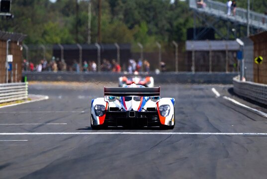A powerful prototype racing car on the asphalt track during a high-speed motorsport event